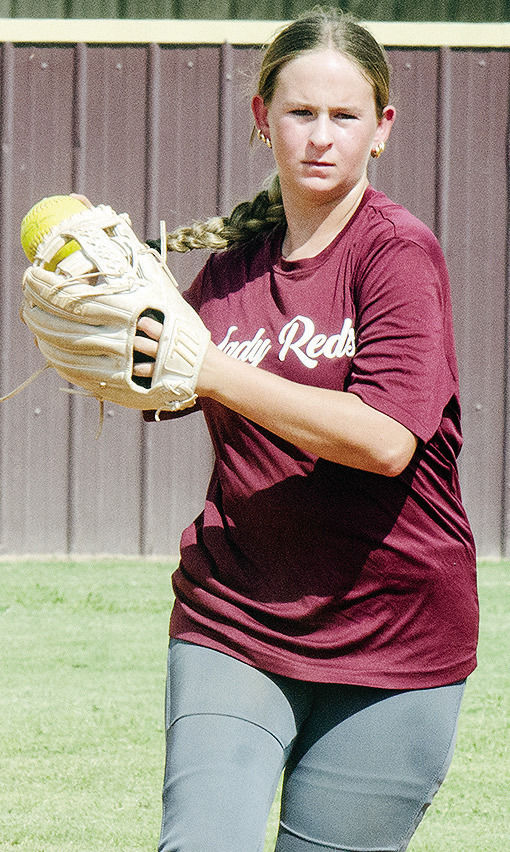 Clinton’s Sydnee Pugh transfers the ball to her hand as she prepares to throw the ball during softball practice. CDN |Sam Goodwyn