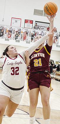 Clinton’s Rhylee Rodebush shoots the ball over a defender during the Lady Reds’ road game Tuesday. CDN | Sam Goodwyn