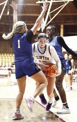 Clinton’s Brooklyn Aston drives between two Newcastle players during the Lady Reds’ home game Thursday against the Lady Racers. CDN | Sam Goodwyn