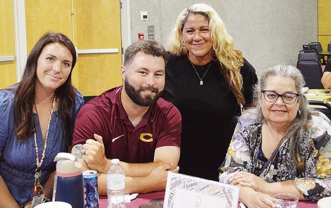From left, Clinton Middle School math teacher Sarah Kerr, history teacher Robert Gordon, discretionary assistant Micah Williams, and Clinton High School librarian Christy Manhart share a table at the Clinton Public Schools’ all-staff gathering Wednesday