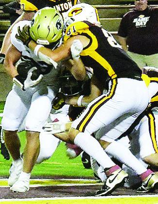 No. 81 Ben Daugherty takes down the Heritage Hall player during Clinton’s home opener Friday against the Chargers in the Tornado Bowl. CDN | John Kinsey