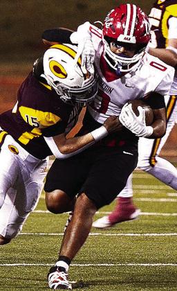 Clinton’s No. 15 Dyson Moss tackles the Elgin ball carrier during the Red Tornadoes’ homecoming game against the Owls Friday in the Tornado Bowl. CDN | Micah Ashcraft