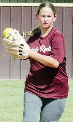 Clinton’s Sydnee Pugh transfers the ball to her hand as she prepares to throw the ball during softball practice. CDN |Sam Goodwyn