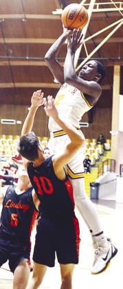 No. 12 Atticus Thompson rises over a Lindsay defender as he shoots the ball during Clinton’s home opener against the Leopards Saturday in the Tornado Bowl. CDN | Sam Goodwyn
