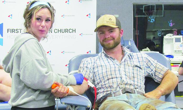 Kiersten Kayleen, left, prepares Greyson Weedon to give blood Tuesday at the Our Blood Institute Blood drive at First Christian Church’s Family Life Center.