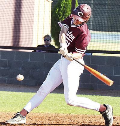 Clinton’s Ayden Crumley focuses on the ball as he swings the bat during the Reds’ home game against Okarche. CDN | Sam Goodwyn