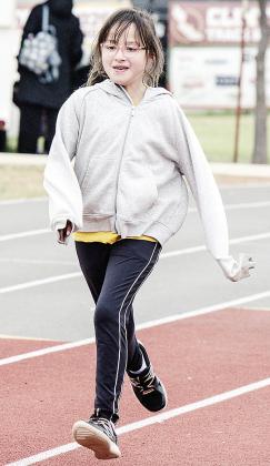 Aubrey Carlson runs on the track during Little Olympics at the high school. CDN |Sam Goodwyn