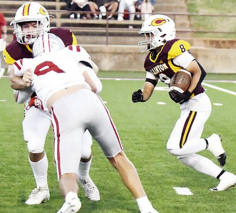 Clinton’s Benton Bridgeman, left, blocks Weatherford’s Kalen Clift, as No. 8 Jaden Potter hustles through with the ball during the Red Tornadoes’ win in the “Custer County Conflict” Friday in the Tornado Bowl. CDN | John Kinsey