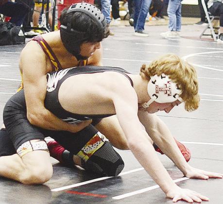 Matthew Bermea, top, grapples with his opponent during the regional tournament Friday in Weatherford. CDN | Sam Goodwyn