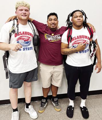 Malachi Lorne, right, celebrates with teammate Marcus Wilson, left, and Clinton wrestling assistant coach Josue Martinez after his bout Wednesday in the All-State wrestling match in Catoosa. CDN | Courtesy photo