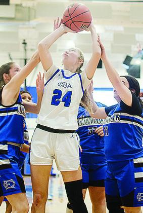 CBA’s No. 24 Brylie Driskill fights through multiple Olustee-Eldorado defenders as she goes up for the layup. CDN | Sam Goodwyn