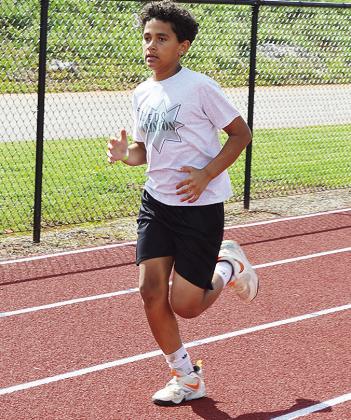 Camryn Washington runs during a relay for the Little Olympics at the high school. CDN | Sam Goodwyn