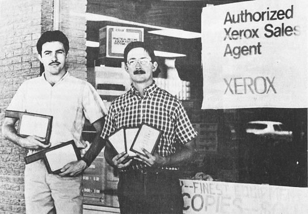 40 YEARS AGO Carl Powell, left, and Jeff Linderer, displayed the five awards of excellence presented to Powell and Linderer Printing and Office Supply in Clinton by Jerry Schroeder, head of the Oklahoma Xerox division.