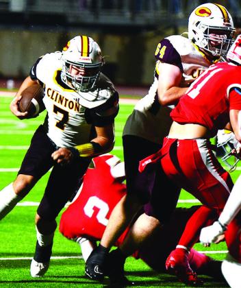 Clinton’s No. 7 Easten Powell cradles the ball as he runs around a block provided by No. 64 Connor Richardson during the Red Tornadoes’ road game in Cache. CDN | Micah Ashcraft