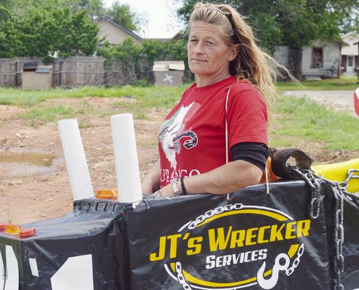 Jennifer Martin stands in a toy train for JT’sWrecking Service at Friday’s Cinco de Mayo parade on Frisco Avenue.