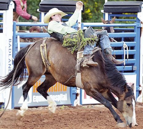 Pauls Valley’s Austin Stratman holds on in the bareback riding event of the rodeo Saturday in the Clinton Round-up Club Arena. CDN | Sam Goodwyn