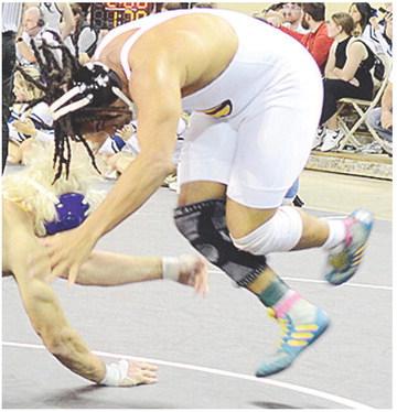 Clinton’s Malachi Lorne swings himself around his opponent as he avoids a move during the Class 4A State Championship match at the Jim Norick Arena. CDN | Sam Goodwyn