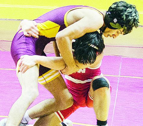 Clinton’s Brandon Rodriquez-Escalante, top, grapples with the Hinton wrestler during the Reds’ season-opening match Thursday in the Tornado Dome. CDN | Sam Goodwyn