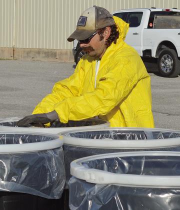 Cody Dillard disposes of several gallons of expired pesticide chemicals for disposal Thursday morning at the Custer County Fairgrounds. CDN | Micah Ashcraft