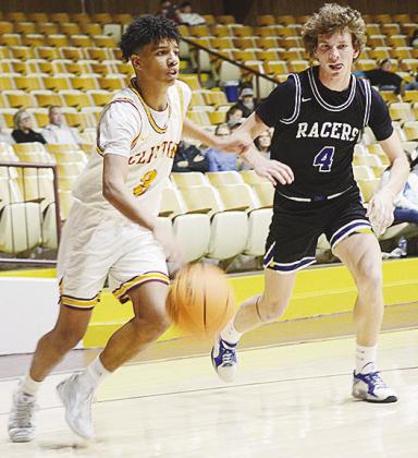 No. 3 Titan Malone dribbles by a Newcastle defender on his way to the hoop during Clinton’s home game against the Racers. CDN | Sam Goodwyn