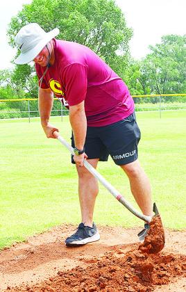Rhett Blundell fixes a base Tuesday at Schumacher Fields at Acme Brick Park in preparation for the OK Kids 8U Baseball State Tournament starting today. Sixteen teams will be playing in Clinton throughout the weekend in the double-elimination tournament. C