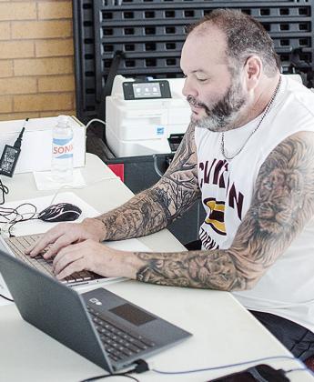 Chris Maley works on the computer to update the brackets during the first day of the recent Hub City Wrestling Tournament at the Tornado Dome. CDN | Sam Goodwyn