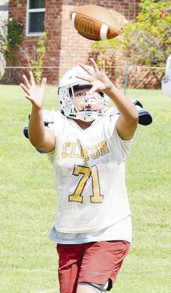 Clinton’s Damars Ellis catches the ball during a route-running drill in practice at the middle school. CDN | Sam Goodwyn