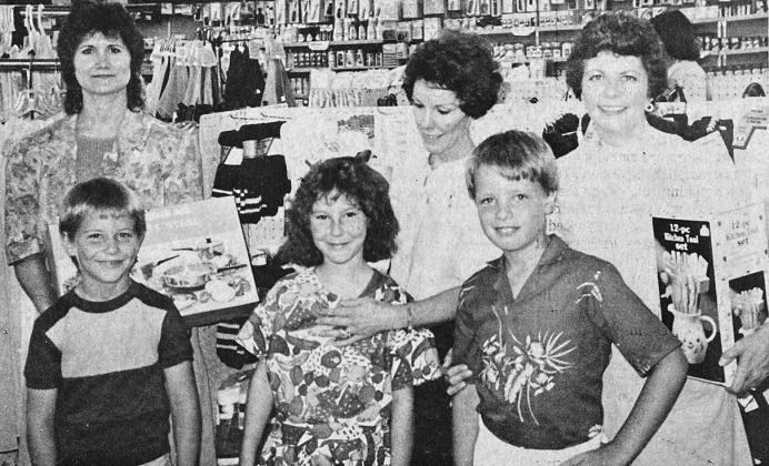 40 YEARS AGO Clinton’s Dollar General Store sponsored a “Why My Mom is the Best” essay contest for Annie Scarlett’s secondgrade class in honor of Mother’s Day. Store manager Gerry Kirkman presented each child a silk rose to take to his or her mother and gifts to the top three placers for their mothers. Shown here with their gifts from left, were Jason Duncan and his mother, Debbie, first; Cindy Wells and her mother, Edna, second; and McCary Rodolph and his mom, Nancy, third.
