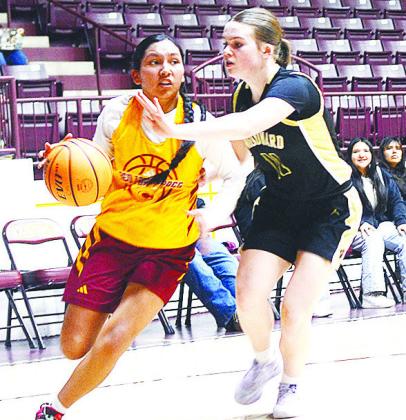 AJ Spottedwolf drives by a Woodward defender during the Clinton Lady Reds’ JV game against the Lady Boomers at the Tornado Dome. CDN | Sam Goodwyn