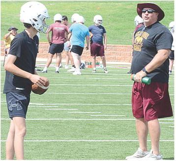Snider Dowdell, left, gets coached up by Head Coach John Higbee during practice. CDN | Sam Goodwyn