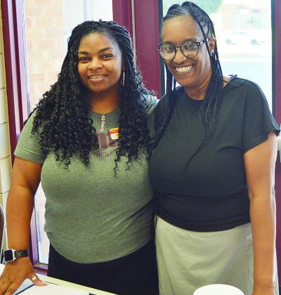 Asst. Resource Coordinator Kimberly Hurd, left, and Tosha Jones with Eastside Acadamy share a table during in-person enrollment at Clinton Middle School. CDN | Micah Ashcraft