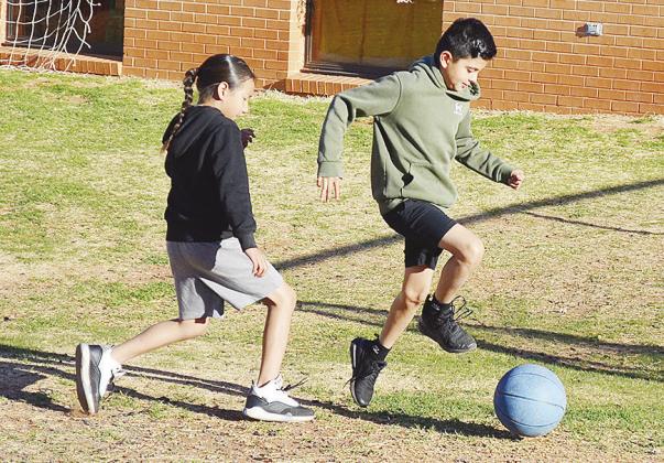 Bryan Rodriguez Guerra, right, outraces Na’tsis’ta Black for the soccer ball during recess at Southwest. CDN | Sam Goodwyn
