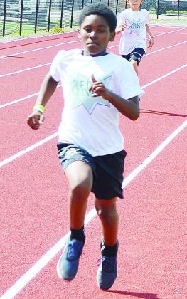 Cordae James hustles in a race during the Little Olympics at the high school. CDN | Sam Goodwyn