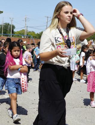 Catalina Arriaga, left, holds her bubble and keeps her hug as she walks in line to go to lunch behind kindergarten teacher Libby Gregston at Nance Elementary. CDN | Christian Jacobsen