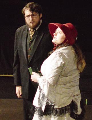 Jacob Staggs, left, as Ebenezer Scrooge, and Amy Baker as the Charity Lady act out a scene together during the Southwest Playhouse’s production of “A Christmas Chaos.” CDN | Micah Ashcraft
