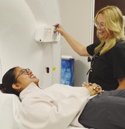 Radiology Technologists Alondra Ortiz, left, and Jaquoah Lemons demonstrate the use of Clinton Regional Hospital’s newly acquired CT scanner. CDN | Micah Ashcraft