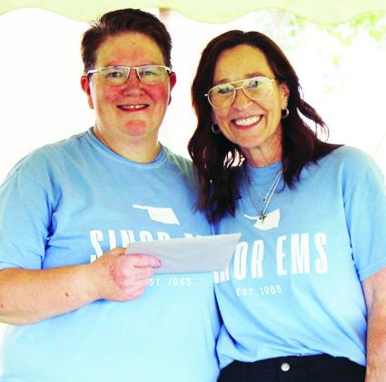 EMS Director Michelle Addington, left, is recognized for her 25 years of service by Sinor CEO Anne Lambeth.