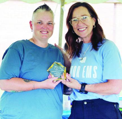 Kaleigh Wilson, left, receives her Paramedic of the Year Award from Sinor CEO Anne Lambeth. CDN | Courtesy photo
