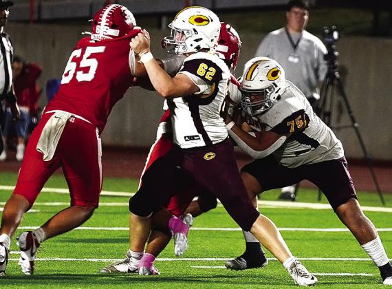 Clinton’s No. 62 Layne Spitz and No. 75 Eli Anderson block Cache defenders during the Red Tornadoes’ road game Thursday against the Bulldogs. CDN | Micah Ashcraft