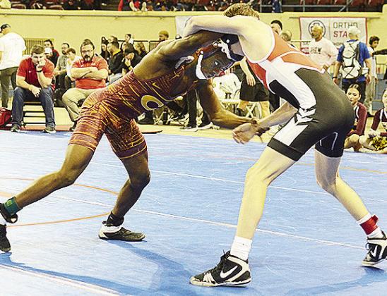 Clinton’s Marquis Martin, left, grapples with his opponent during the consolation bracket of the 4A State Wrestling Tournament Saturday at the Jim Norick Arena in Oklahoma City. CDN | Sam Goodwyn