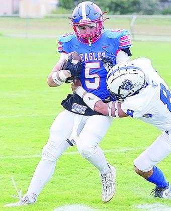 No. 5 Alex Harrison fights through a tackle during BF-DC’s home game Friday against Cyril. CDN | Sam Goodwyn