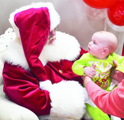 Tripp Mandrell meets Santa Claus at the Pepsi Event Center during the Clinton Festival of Lights. CDN | Micah Ashcraft