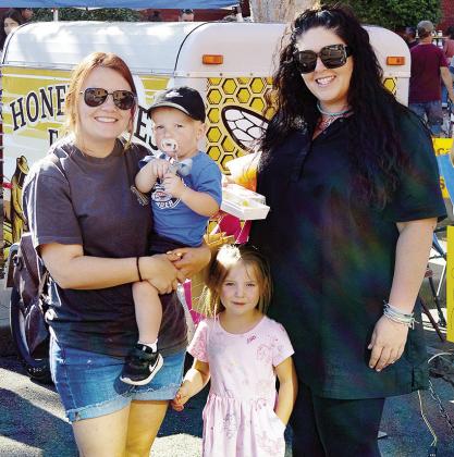 Leksi Richert, left, with her children Luke and Riley Richert, and Shakira Thigpen all enjoy the good weather and the Clinton Farmers Market Thursday at Engleman Park. CDN | Christian Jacobsen