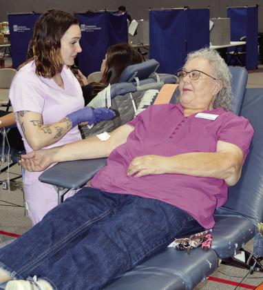 Phlebotomist Nadine Nichols, left, bandages up Donna Szedeli from her donation of blood toward the Clinton Community Blood Drive Tuesday at the First Christian Church.