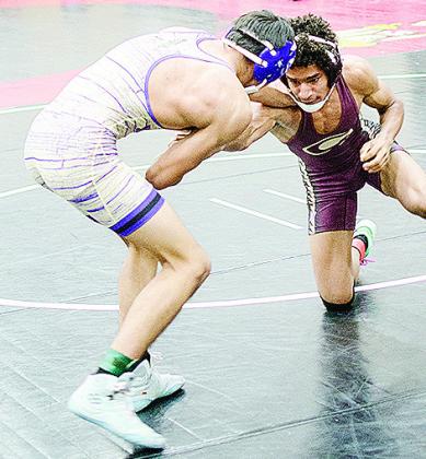 Clinton’s Jeremiah Grimes, right, goes for a sweep of his opponent’s legs during the recent Max Dippel Wrestling Tournament. CDN | Sam Goodwyn