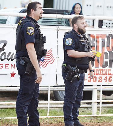 Officers Cody Burton, left, and Dillon Whitten act serious in a comedy bit during the Clinton Round-Up Rodeo Saturday night in the Round-Up Arena.