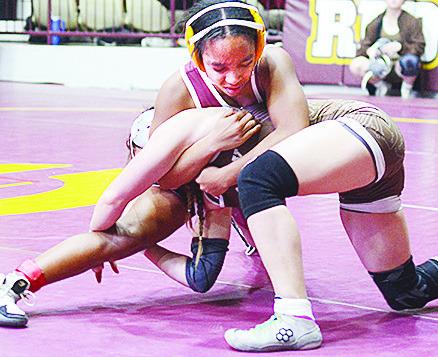 Clinton’s Peyton Clonce wraps her opponent up to avoid a single-leg takedown during the Hub City Wrestling Tournament held at the Tornado Dome. CDN | Sam Goodwyn
