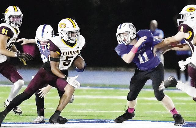 Clinton’s No. 81 Judd Hall and No. 6 Benton Bridgeman provide key blocks to help spring Jesus Gutierrez and allow him to carry the ball for a big gain Friday against Bridge Creek. CDN | John Kinsey