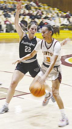 Clinton’s Lillian Lime drives the ball toward the basket against a Weatherford defender during the Lady Reds’ game against the Lady Eagles. CDN | Sam Goodwyn