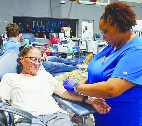 Sherry Ernst, left, is prepped to donate blood by Whitney Gilder Tuesday afternoon at the blood drive held at the First Christian Church’s Family Life Center. CDN | Micah Ashcraft